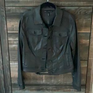 Black denim, shiny. Stretches.